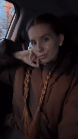 Woman passenger with braids recorded in car in Klin