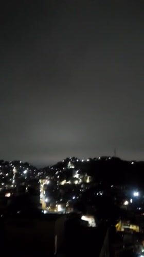 Nighttime views of illuminated Caracas captured from multiple vantage points