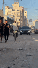 Everyday street life along a dirt road in Gaza