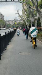 Morning commuters cycle and walk through Shanghai streets