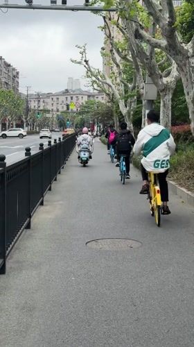 Morning commuters cycle and walk through Shanghai streets