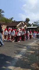 Traditional street procession winds through Trenggalek in red and white
