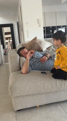 Man with toy rests on couch in Luxembourg home