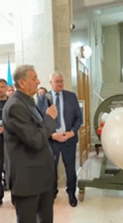 Man in suit speaks at official building in Kyiv