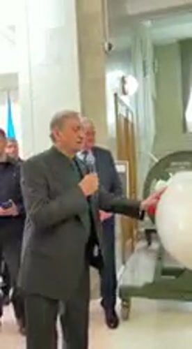 Man in suit speaks at official building in Kyiv