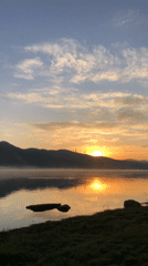 Dawn breaks over misty lake in rural Russia