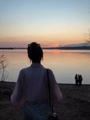 Women photograph sunset moments by Chaikovsky lake