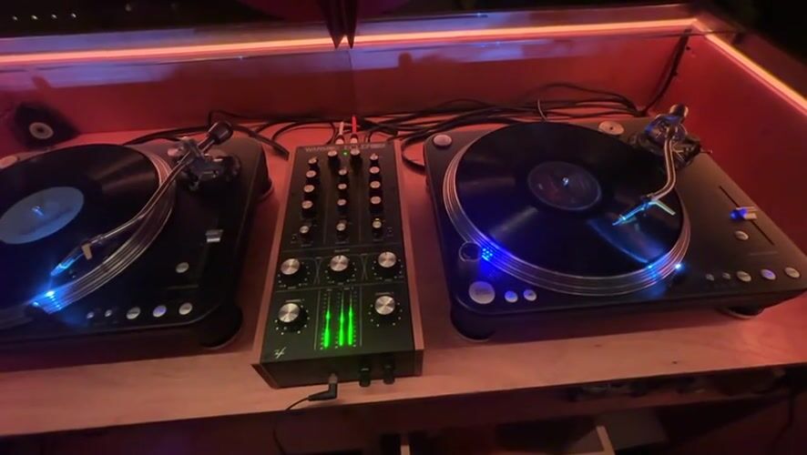 DJ equipment spotted in red-lit Buenos Aires venue