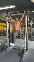 Man performs hanging leg raises at Paris gym