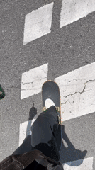 Skateboarder cruises Barcelona streets on sunny spring afternoon