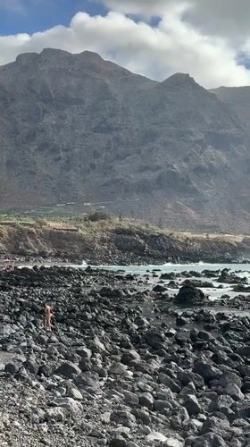 Volcanic coastline, crashing waves, and mountain views