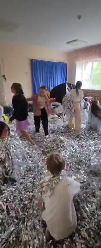 Children play in tinsel-filled room in Krasnogorskoye