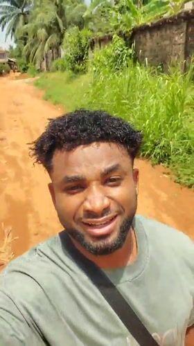 Man records cheerful selfie video on dirt road in Nigeria