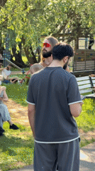 Group gathers outdoors in Moscow, man carries child