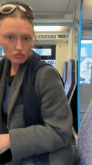 Woman demonstrates sunglasses on London train journey
