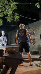 Evening table tennis game at illuminated Arugam Bay venue
