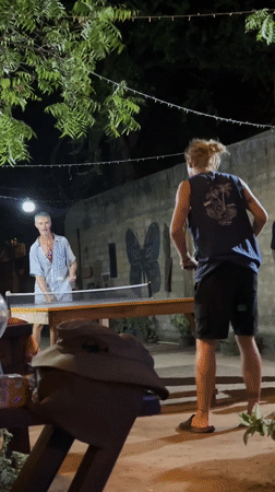 Evening table tennis game at illuminated Arugam Bay venue