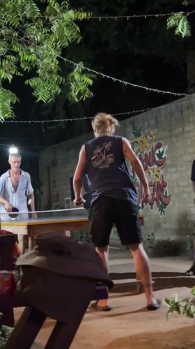 Evening table tennis game at illuminated Arugam Bay venue