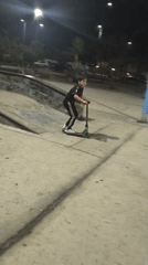 Youth rides scooter at nighttime skate park in Arica