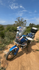 Motorcycle and fire pit documented in Tangier countryside