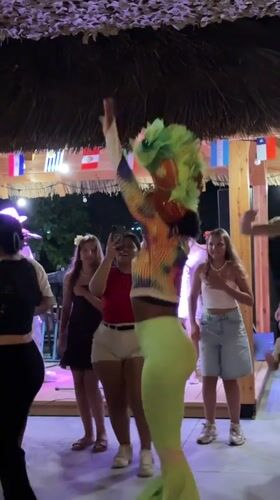 Carnival dancers and live music at a Boreti outdoor venue