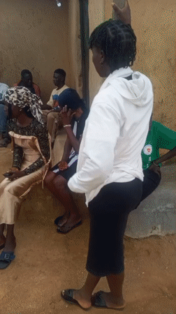 Afternoon gathering outside rural structures in Ohit, Nigeria