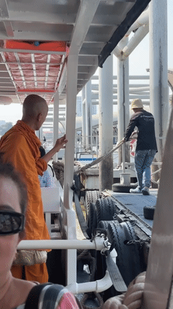 Buddhist monk observed at Bangkok's Wat Arun temple pier