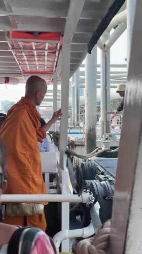Buddhist monk observed at Bangkok's Wat Arun temple pier