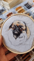 Embroiderer works on detailed dog portrait in Ust-Ilimsk