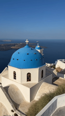 Blue-domed church against the Aegean in Santorini