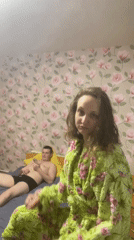 Couple photographed in bedroom, person shows bandaged fingers