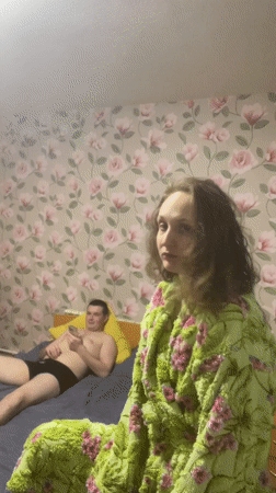 Couple photographed in bedroom, person shows bandaged fingers