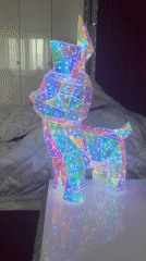 Illuminated geometric deer figurine with rainbow lights captured by witnesses