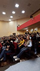 Young woman presents to packed auditorium in Glazov, Russia
