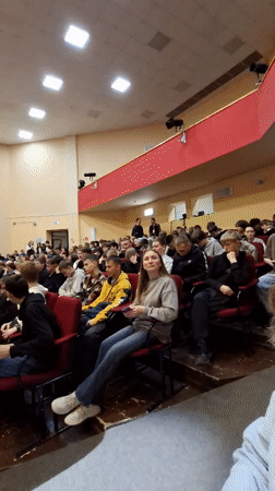 Young woman presents to packed auditorium in Glazov, Russia