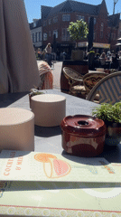 Outdoor café scene captured in Hengelo on sunny morning