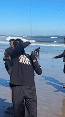 Young men fly kites on North Kuta beach morning