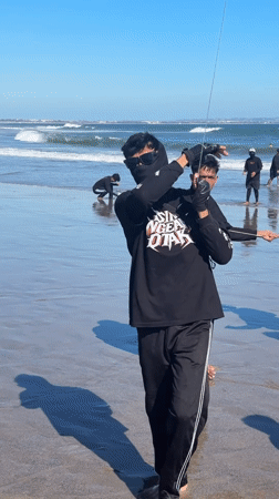 Young men fly kites on North Kuta beach morning