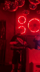 Musicians perform live set in red-lit Milan venue
