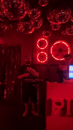 Musicians perform live set in red-lit Milan venue