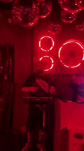 Musicians perform live set in red-lit Milan venue