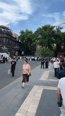 Crowd marches through central Yerevan in white shirts