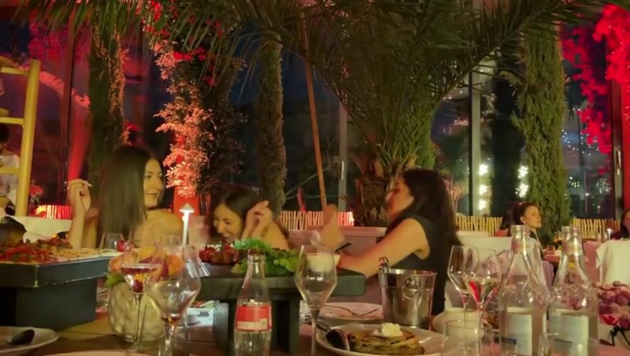 Evening celebration at a red-lit tropical restaurant in Yerevan