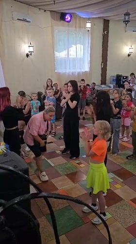 Children and adults gathered indoors for an activity in Ulitkino