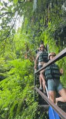 Two equipped individuals descend stairs in Payangan, Indonesia