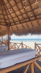 Beachfront massage area and jet ski activity captured in Playa del Carmen