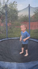 Toddler plays on backyard trampoline in Ферма, Russia