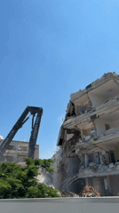 High-reach excavator dismantles multi-story building on Tel Aviv coast
