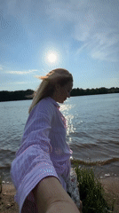 Woman enjoys sunny afternoon along Volkhov River in Kirishi