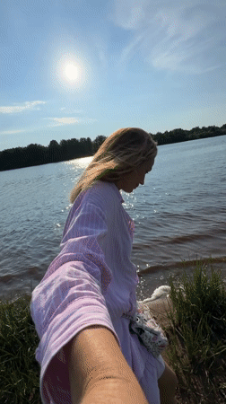 Woman enjoys sunny afternoon along Volkhov River in Kirishi